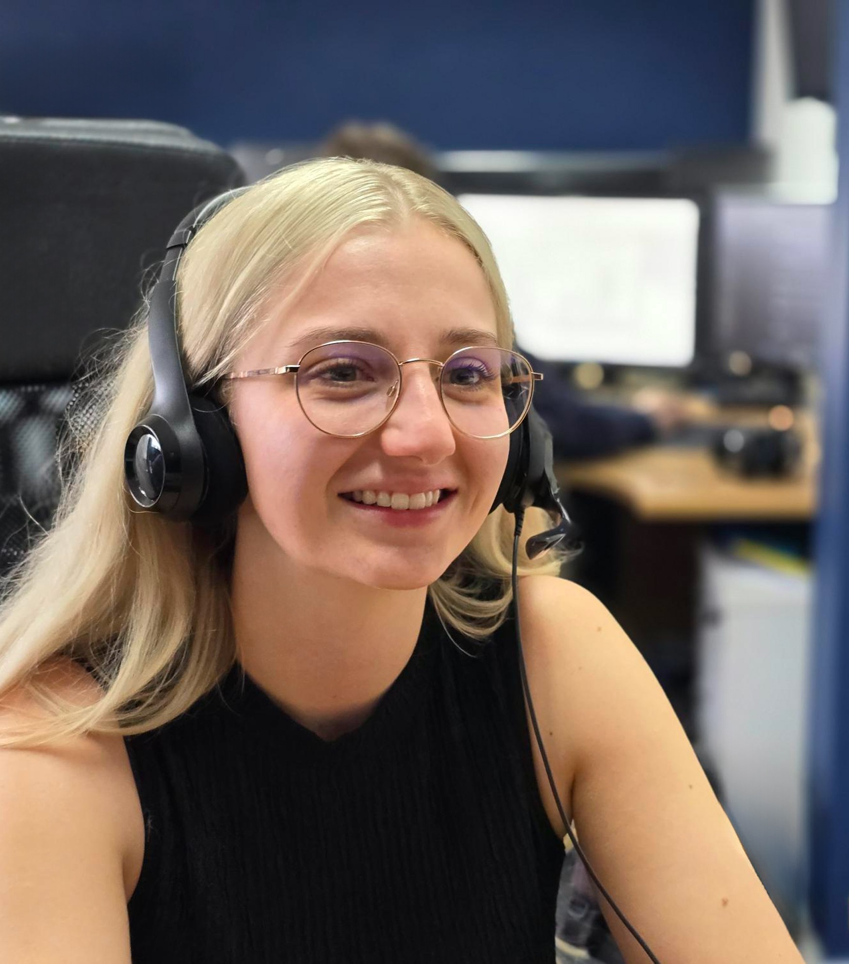 A photo of Paige smiling and providing IT support