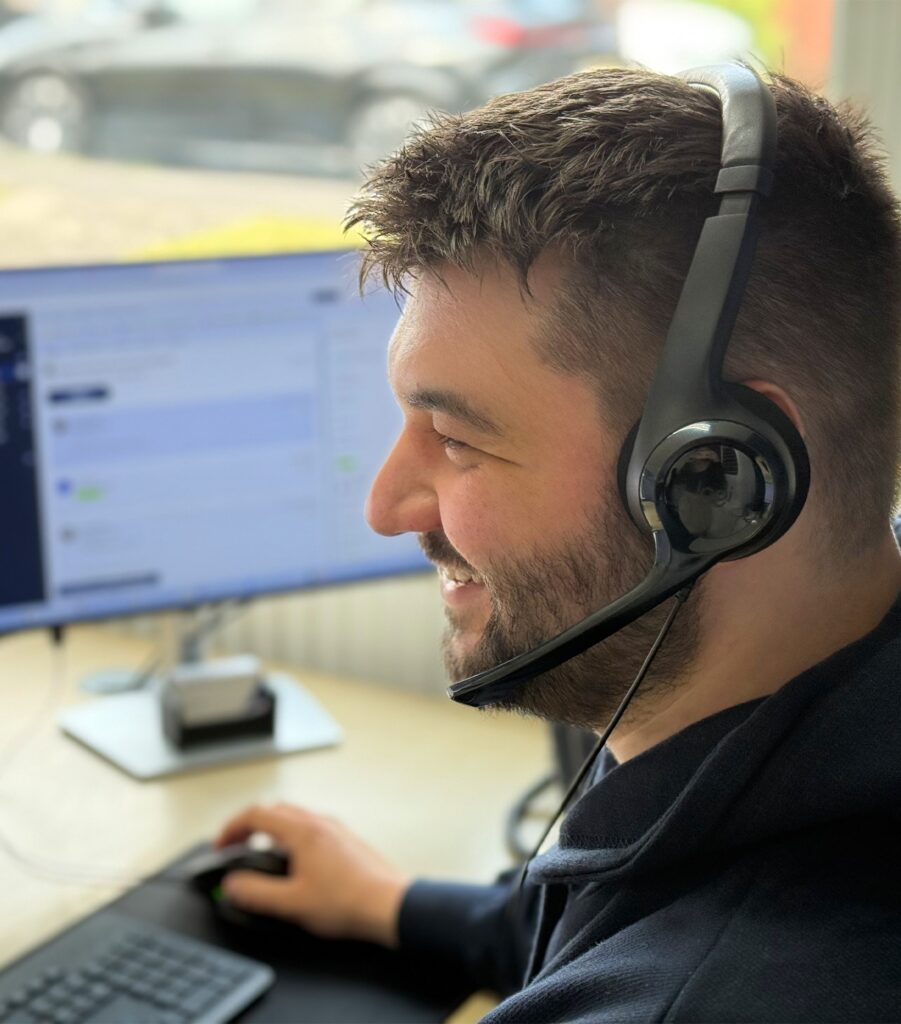 A photo of Ryan smiling and providing IT support